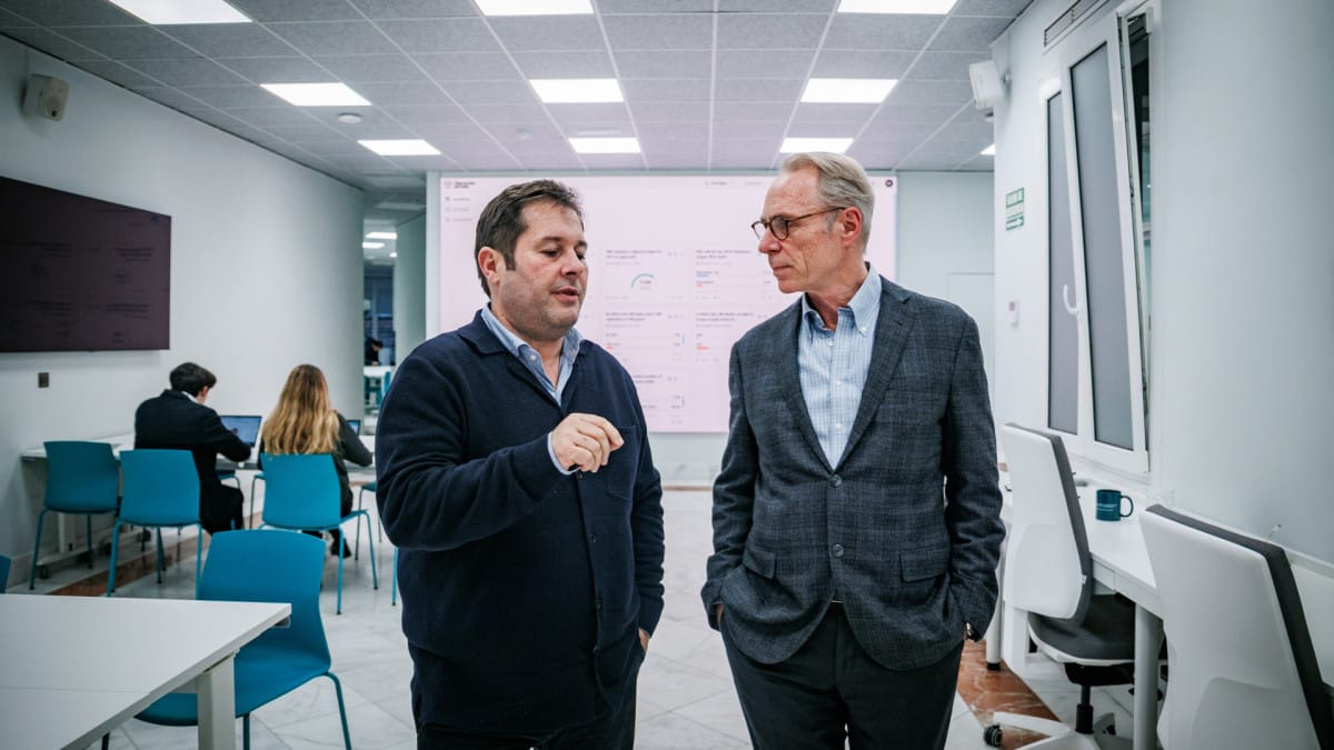 Two people discussing forecasts in front of a forecasting dashboard
