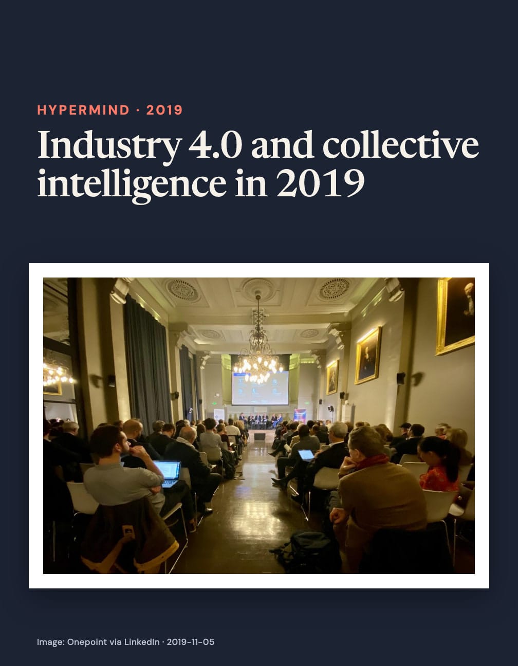 “Industry 4.0 and collective intelligence in 2019” above a photograph of an audience facing a panel and projection screen in a hall with chandeliers and framed portraits on navy.