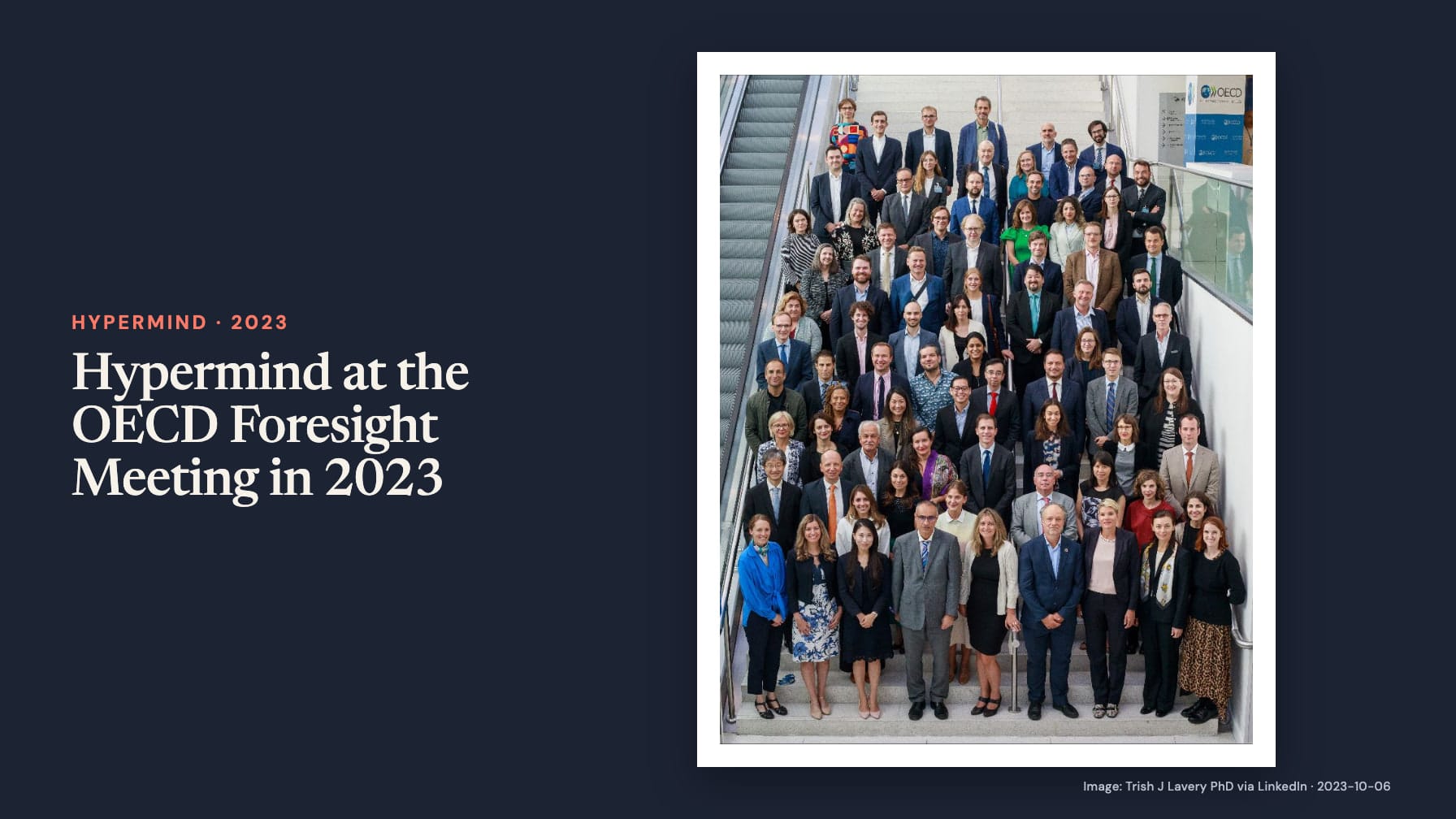“Hypermind at the OECD Foresight Meeting in 2023” sits beside a group photograph of dozens of people arranged on an indoor staircase beside an escalator and an OECD sign.