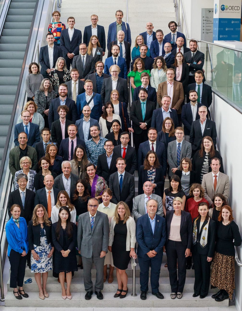 The OECD Government Foresight Community’s 2023 family photo: members gathered on a staircase at the OECD.