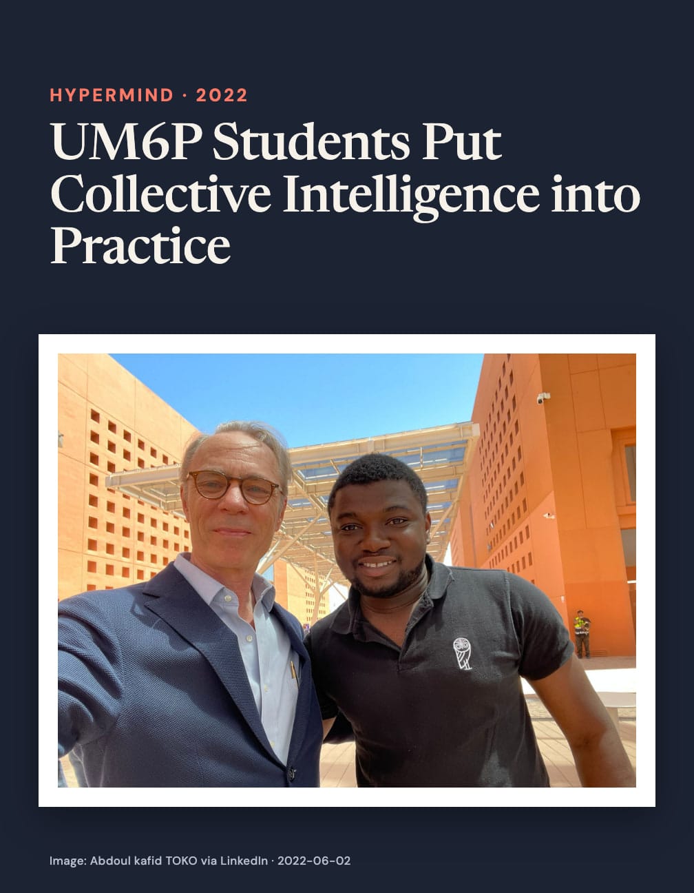 “UM6P Students Put Collective Intelligence into Practice” appears above a selfie of two men, one in glasses and a blue blazer and the other in a black polo shirt, between orange buildings under a blue sky.